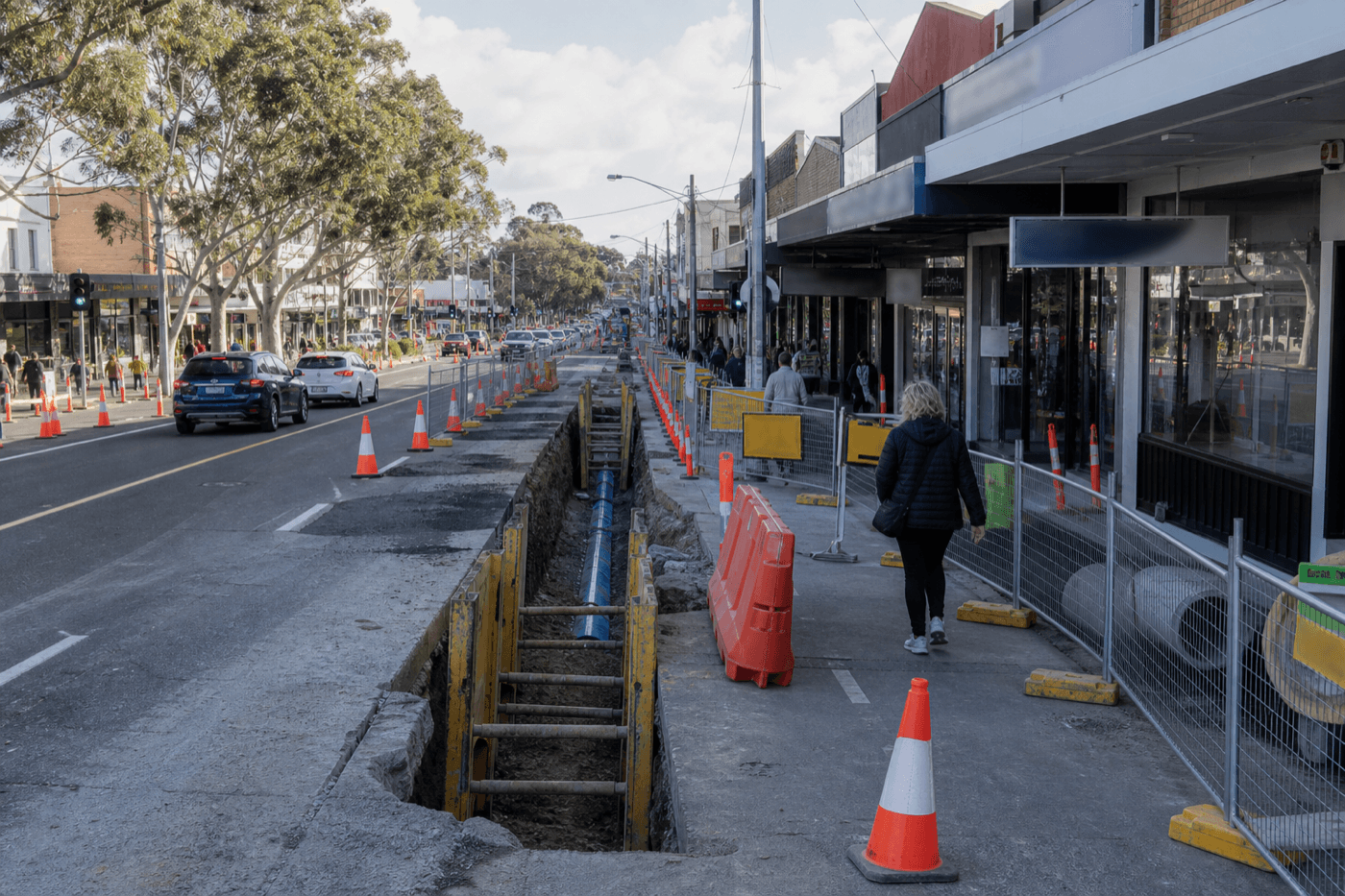 NSW potable water main renewal corridor with staged pavement reinstatement and traffic management along a suburban shopping strip